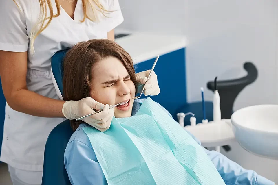 fearful-child-is-squinting-during-dental-procedure Emergency Dental Care Guide: Pain, Swelling, and Possible Infection